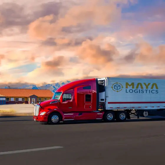 Tractor-trailer parked at sunset